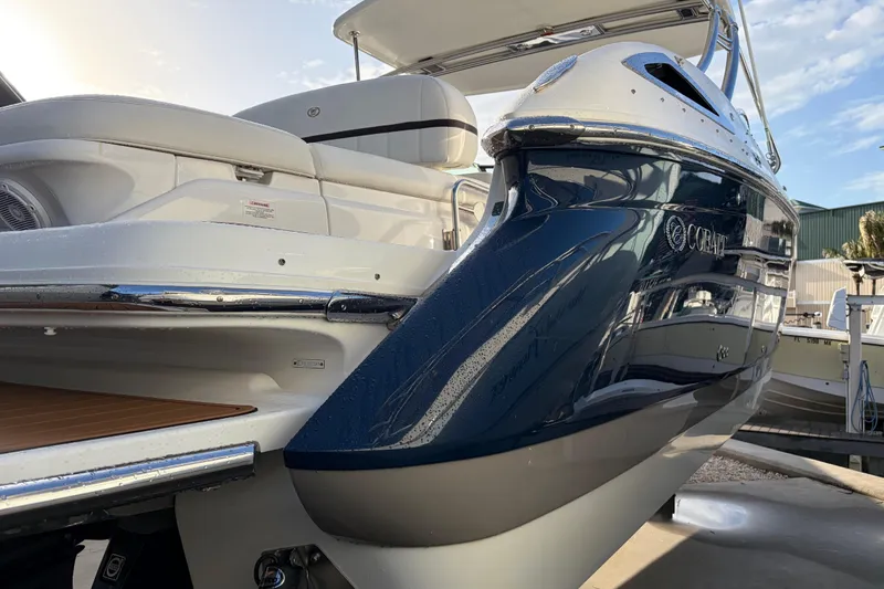 Slide: The Image of 2015 Cobalt 336 boat with sleek design and luxurious seating, docked outdoors. - 6