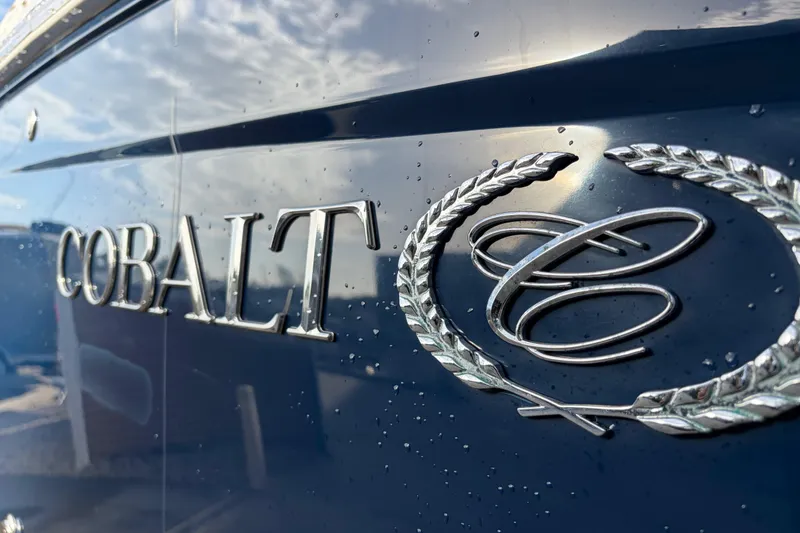 Slide: The Image of 2015 Cobalt 336 boat emblem with water droplets on a sleek blue surface. - 7