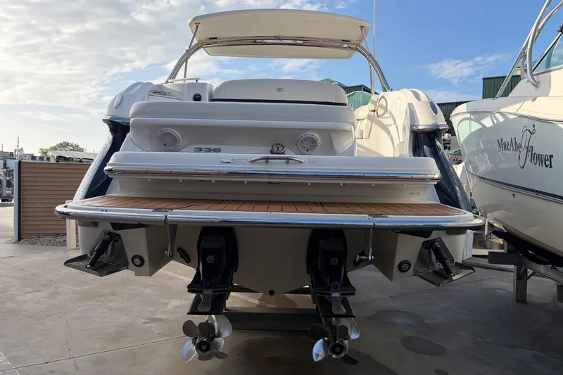 Slide: The Image of 2015 Cobalt 336 boat with dual propellers, docked at a marina under a clear sky. - 8