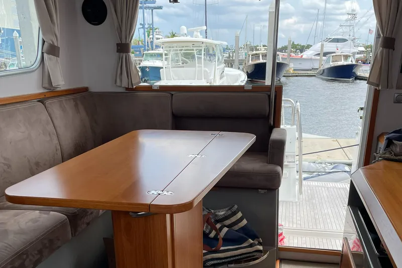 Slide: The Image of Interior of 2015 Sargo 36 Flybridge yacht with dining area and marina view. - 14