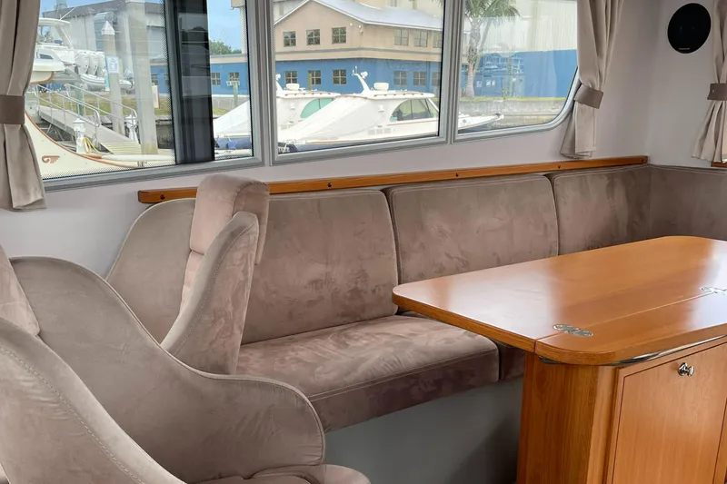 Slide: The Image of Interior of 2015 Sargo 36 Flybridge with plush seating and wooden table. - 15