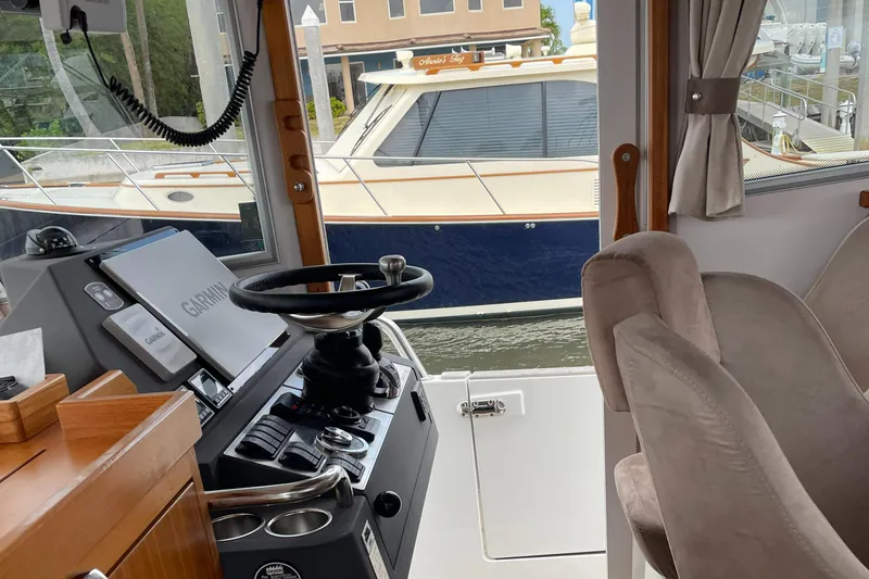 Slide: The Image of Interior view of 2015 Sargo 36 Flybridge boat with steering wheel and controls. - 16