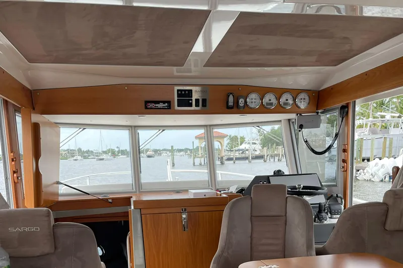 Slide: The Image of Interior view of 2015 Sargo 36 Flybridge boat, featuring helm and seating area. - 17