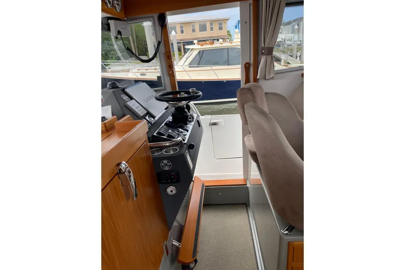 Slide: The Image of Interior view of 2015 Sargo 36 Flybridge boat cockpit with steering wheel and controls. - 19