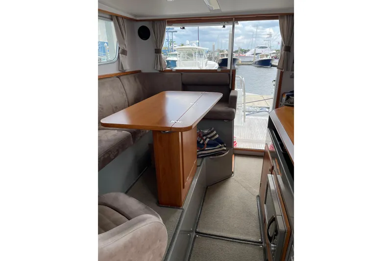 Slide: The Image of Interior of 2015 Sargo 36 Flybridge yacht with dining area and marina view. - 20