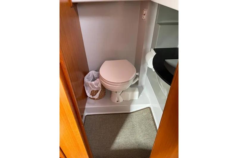 Slide: The Image of Compact bathroom in 2015 Sargo 36 Flybridge boat with toilet and wastebasket. - 21