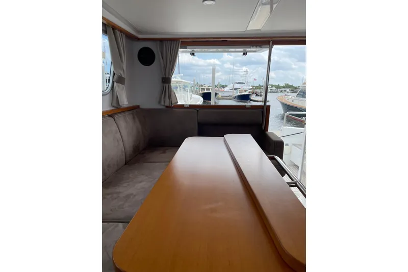 Slide: The Image of Interior of 2015 Sargo 36 Flybridge yacht with dining area and marina view. - 22
