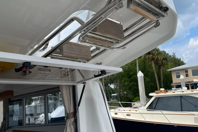 Slide: The Image of Sargo 36 Flybridge 2015 boat detail with open hatch and marina background. - 26