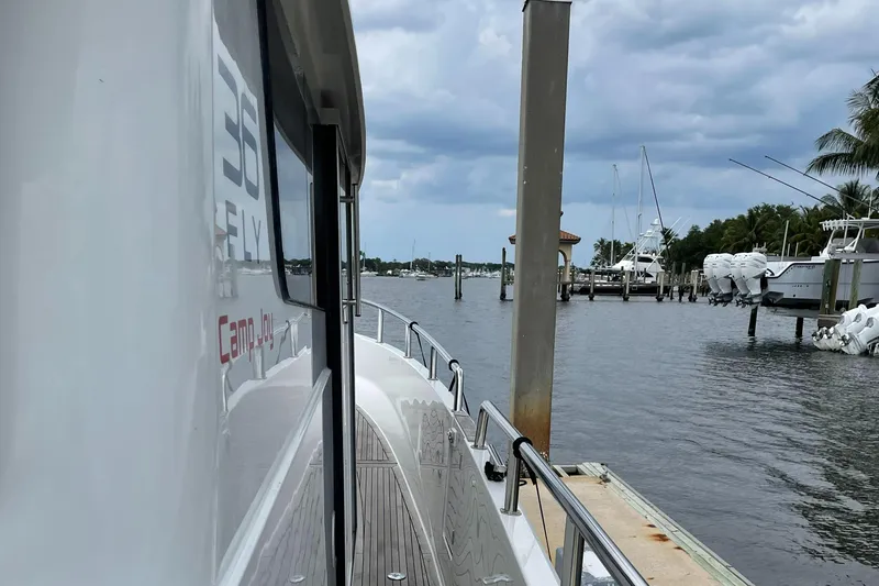 Slide: The Image of Sargo 36 Flybridge 2015 yacht docked at marina, cloudy sky, calm waters. - 27