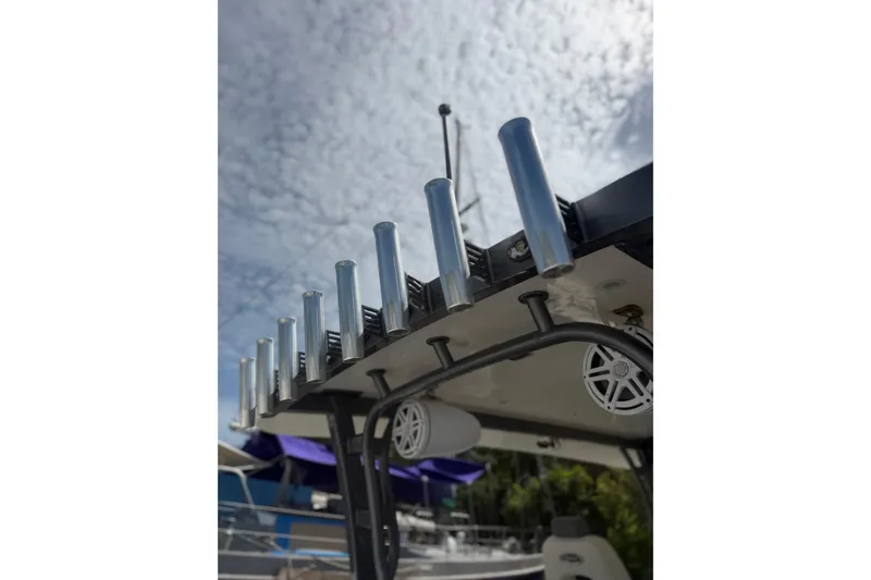 Slide: The Image of Rod holders on a 2017 HCB 53 Suenos boat under a cloudy sky. - 14