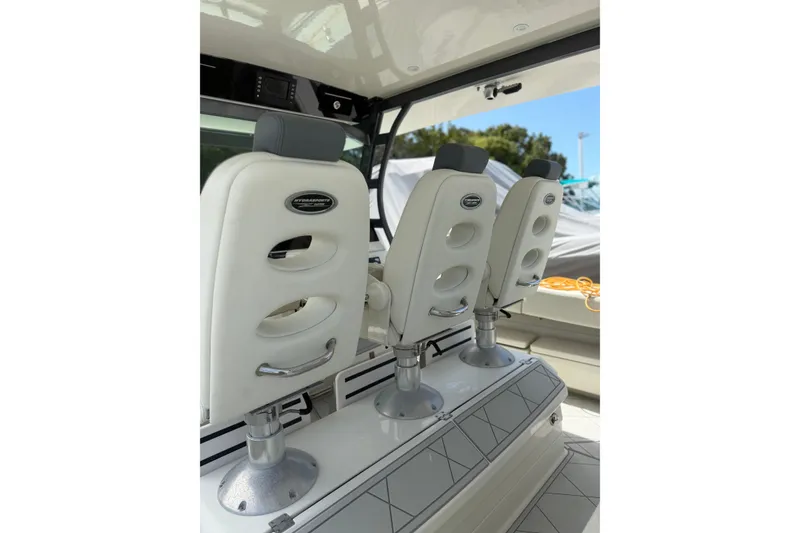 Slide: The Image of Luxury seating on 2017 HCB 53 Suenos boat, featuring sleek white design and modern fixtures. - 18