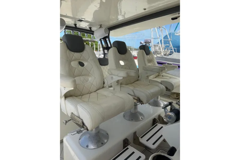 Slide: The Image of Luxurious seating on 2017 HCB 53 Suenos boat, featuring plush white leather chairs. - 19