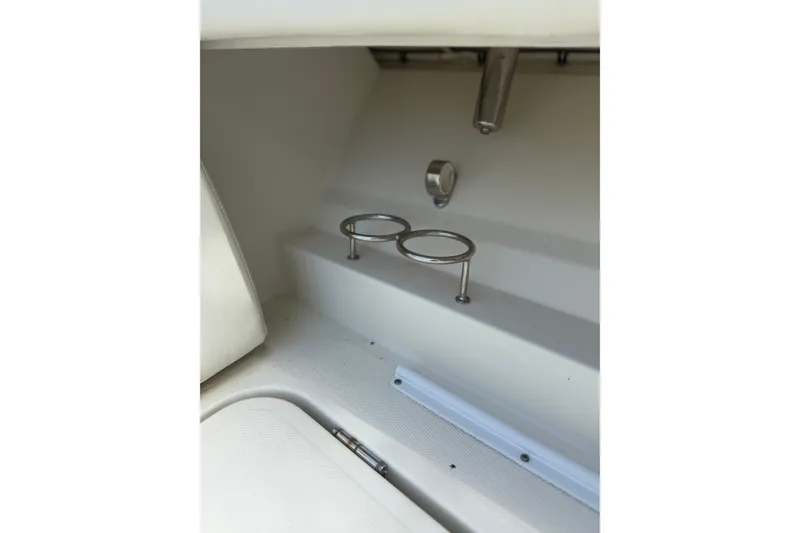 Slide: The Image of Interior detail of 2017 HCB 53 Suenos boat, featuring cup holders and seating area. - 28