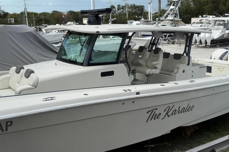 Slide: The Image of 2017 HCB 53 Suenos boat named "The Karalee" docked, featuring luxurious seating and sleek design. - 3