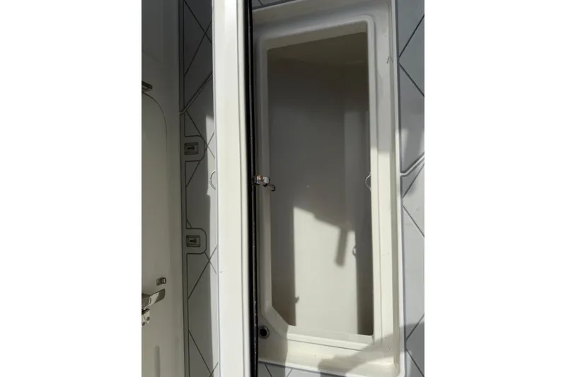 Slide: The Image of Open storage compartment on 2017 HCB 53 Suenos boat, featuring sleek interior design. - 38