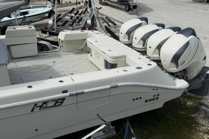 Slide: The Image of 2017 HCB 53 Suenos boat with quad outboard engines, docked on a trailer. - 4