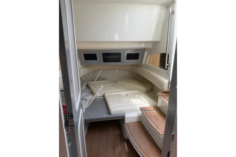 Slide: The Image of Interior cabin of 2017 HCB 53 Suenos boat with cushioned seating and wooden steps. - 48