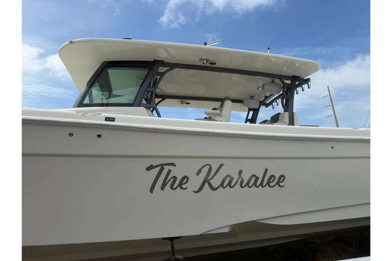 Slide: The Image of 2017 HCB 53 Suenos boat named "The Karalee" under a clear blue sky. - 5