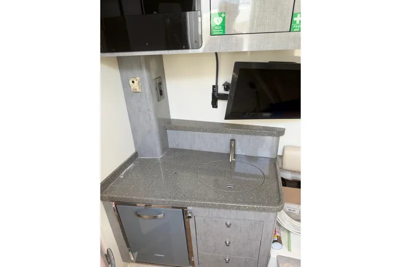 Slide: The Image of Compact kitchenette in 2017 HCB 53 Suenos boat with sink, fridge, and TV. - 50