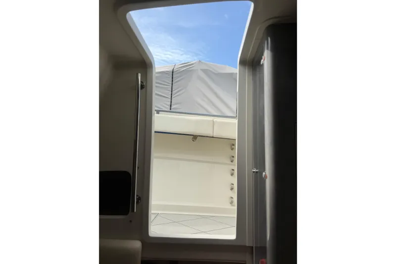 Slide: The Image of Interior view of 2017 HCB 53 Suenos boat, showcasing doorway and partial deck. - 51