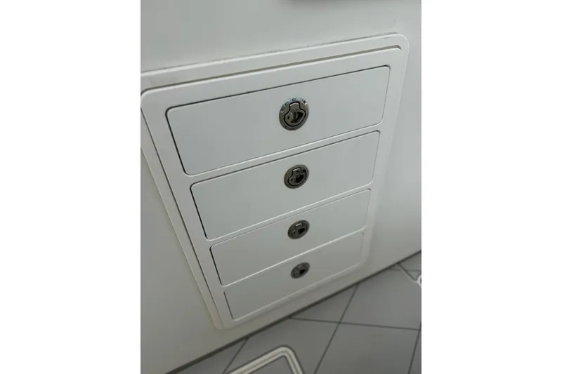 Slide: The Image of White storage drawers on a 2017 HCB 53 Suenos boat interior. - 54