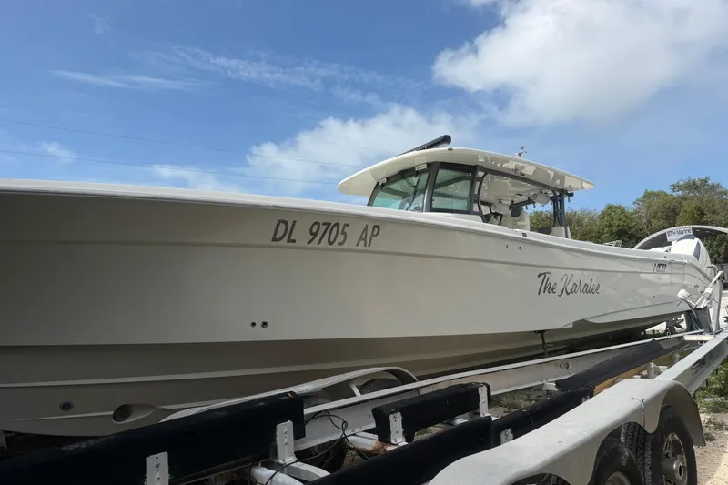 Slide: The Image of 2017 HCB 53 Suenos boat on trailer under blue sky. - 6
