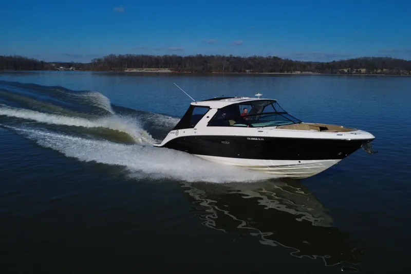 Slide: The Image of 2022 Sea Ray SLX 400 cruising on a calm lake under a clear blue sky. - 19