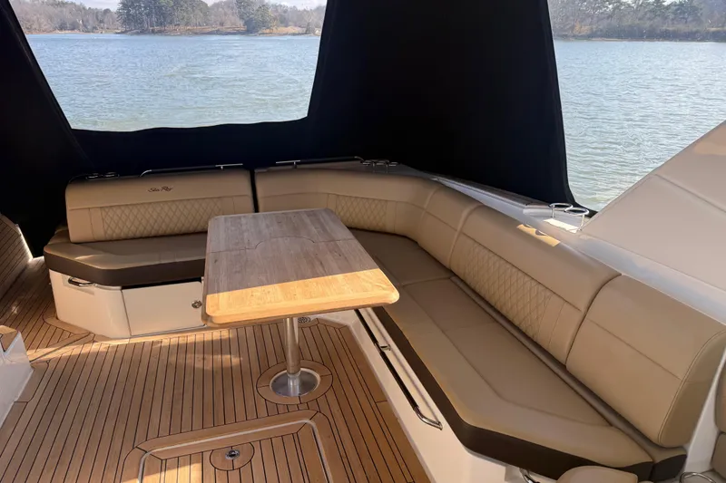 Slide: The Image of Luxurious seating area on 2022 Sea Ray SLX 400 boat with wooden table. - 39