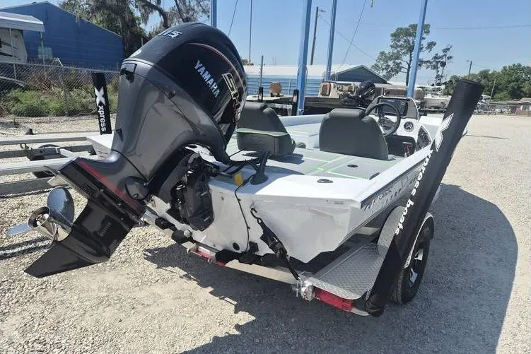 The Image of 2026 Xpress H18 boat with Yamaha outboard motor, parked on a trailer in a sunny outdoor setting. - 0