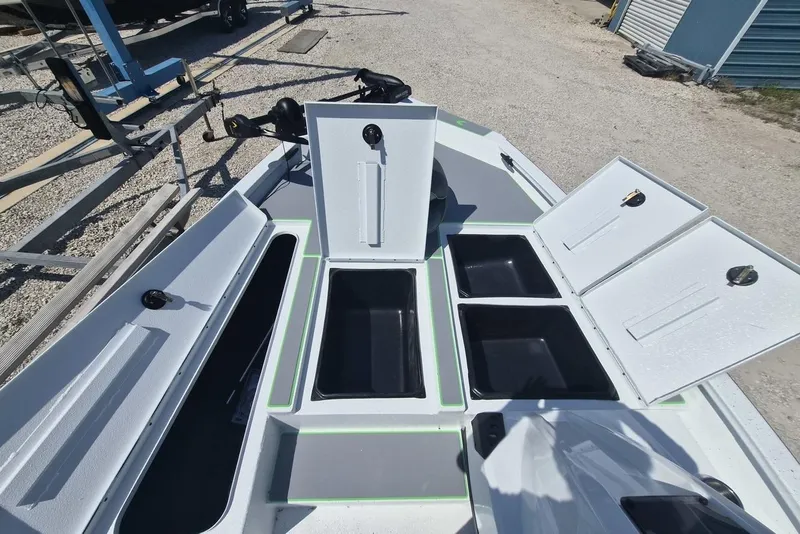 Slide: The Image of Open storage compartments on a 2026 Xpress H18 boat deck. - 7
