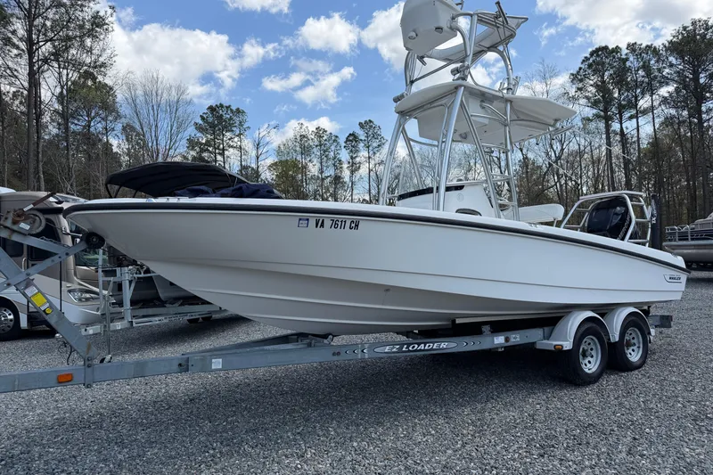 The Image of 2009 Boston Whaler 230 Dauntless boat on trailer, parked outdoors. - 0