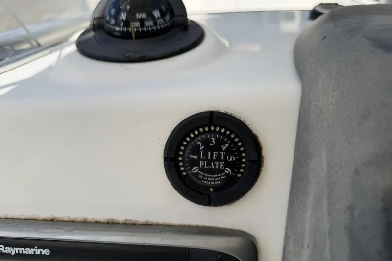 Slide: The Image of 2009 Boston Whaler 230 Dauntless dashboard with compass and lift plate control. - 12