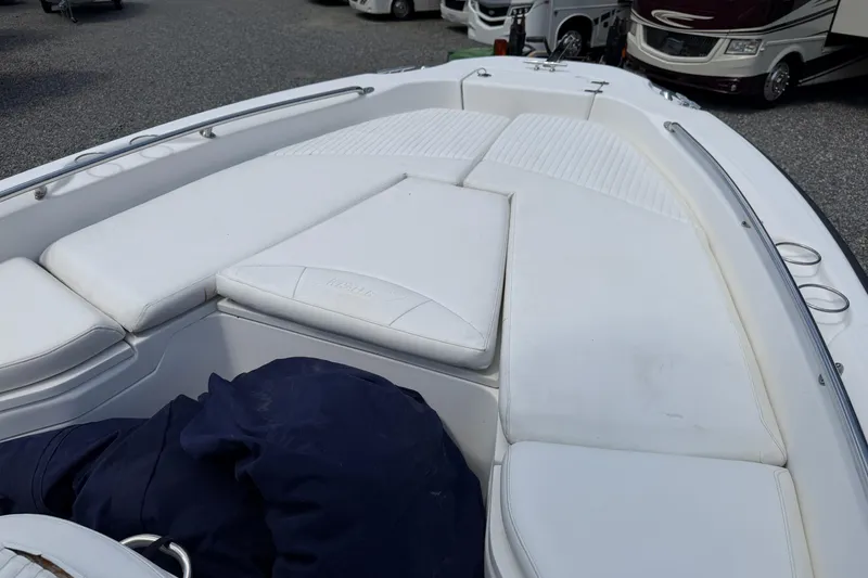 Slide: The Image of 2009 Boston Whaler 230 Dauntless boat with white cushioned seating and stainless steel railings. - 4