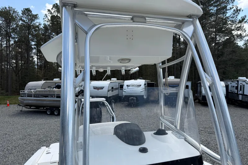 Slide: The Image of 2009 Boston Whaler 230 Dauntless boat with T-top, parked near RVs and trees. - 6