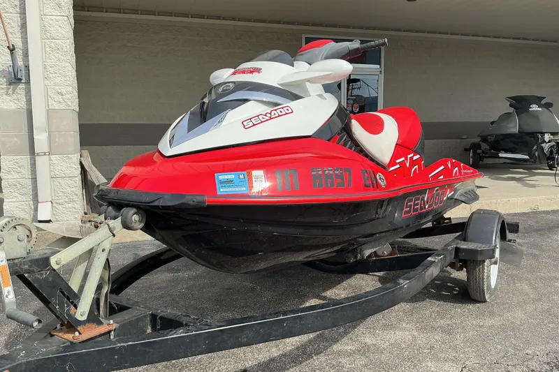 Slide: The Image of 2007 Sea-Doo RXT 215 jet ski in red and black on a trailer. - 2