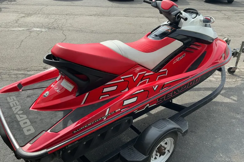 Slide: The Image of 2007 Sea-Doo RXT 215 jet ski in red, parked on a trailer. - 4