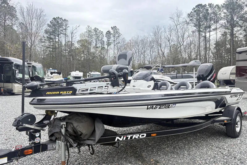 The Image of 2013 Nitro Z-7 boat with Minn Kota motor in a parking lot. - 1