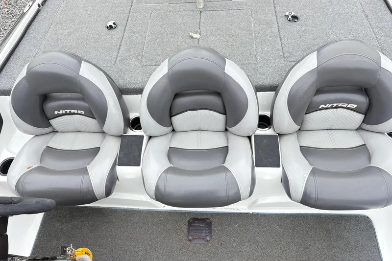 Slide: The Image of Three gray and white Nitro Z-7 boat seats, 2013 model, with cup holders. - 11