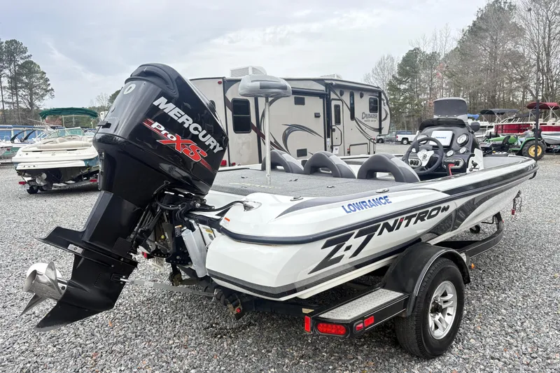 Slide: The Image of 2013 Nitro Z-7 boat with Mercury Pro XS engine in a gravel lot. - 4
