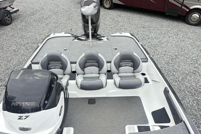 Slide: The Image of 2013 Nitro Z-7 boat interior with three gray seats and carpeted deck. - 7