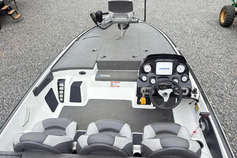 Slide: The Image of 2013 Nitro Z-7 boat interior with steering console and seating on gravel surface. - 8