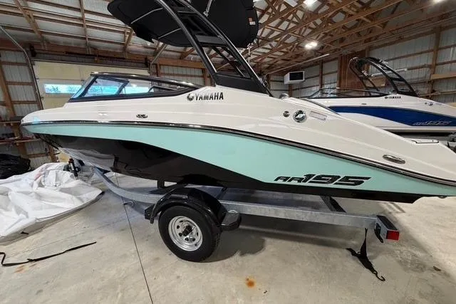 Slide: The Image of 2026 Yamaha Boats AR195 in a storage facility, showcasing sleek design and modern features. - 2
