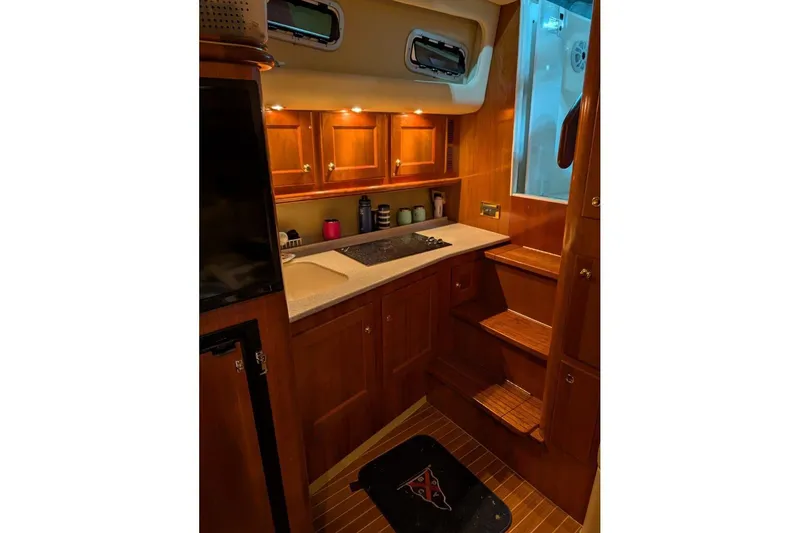 Slide: The Image of Luxurious wooden interior of 2007 Rampage 38 Express yacht kitchen area. - 4