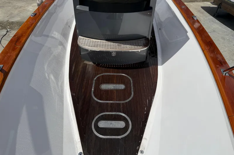 Slide: The Image of Custom 2013 Jet Center Console boat interior with wooden deck and sleek design. - 11