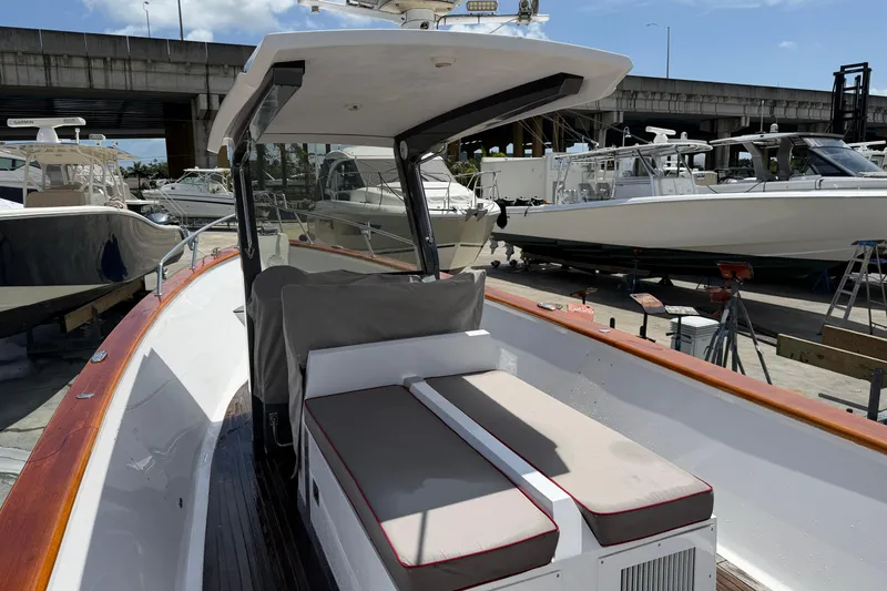 Slide: The Image of 2013 Custom Jet Center Console boat docked, featuring sleek design and comfortable seating. - 15