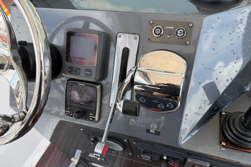 Slide: The Image of Steering console of a 2013 Custom Jet Center Console boat with controls and displays. - 18