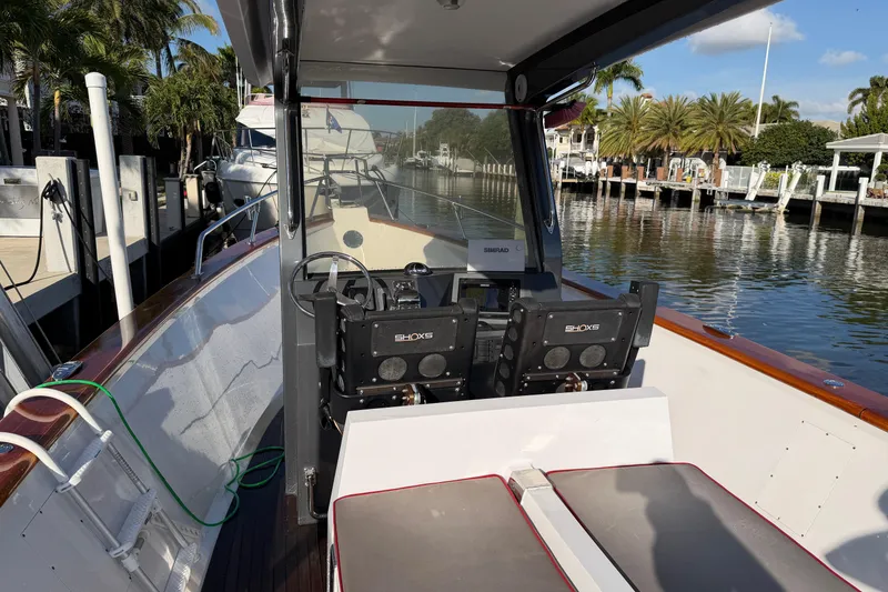 Slide: The Image of 2013 Custom Jet Center Console boat docked by a scenic waterfront. - 19