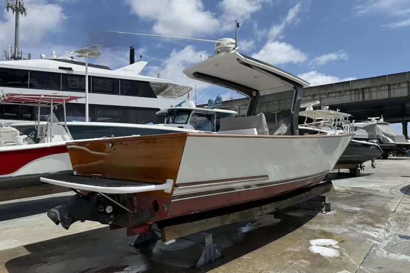 Slide: The Image of Custom 2013 Jet Center Console boat on dry dock under a blue sky. - 2