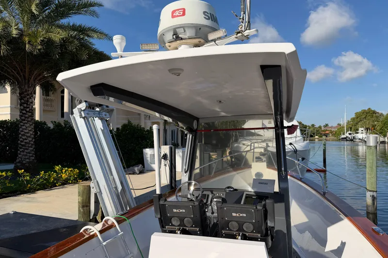 Slide: The Image of Custom 2013 Jet Center Console boat docked, featuring advanced navigation equipment and sleek design. - 21