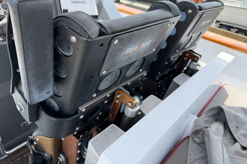 Slide: The Image of 2013 Custom Jet Center Console with SHOCKS seating system, featuring durable materials and design. - 26